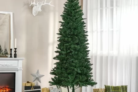 Green artificial Christmas tree decorated beside fireplace and wrapped gifts.
