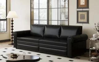Black leather sofa in modern living room with rug.