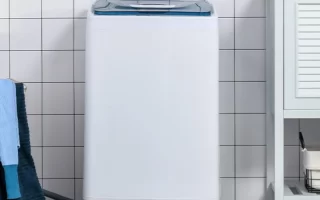 Portable washing machine in laundry area of a house.