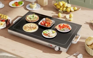 Warming tray with multiple plates of food on table