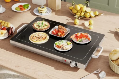 Warming tray with multiple plates of food on table