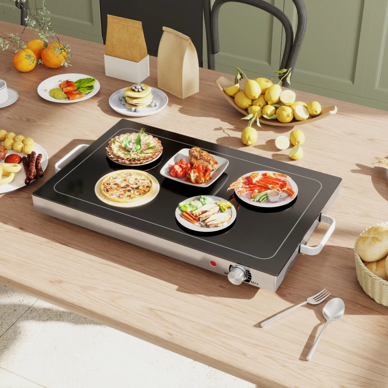 Warming tray with multiple plates of food on table