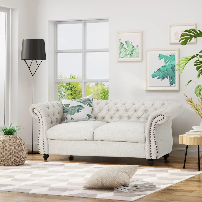 Beige tufted loveseat sofa styled in modern living room.