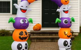 Inflatable Halloween archway with pumpkins, bats, and ghosts outside house.