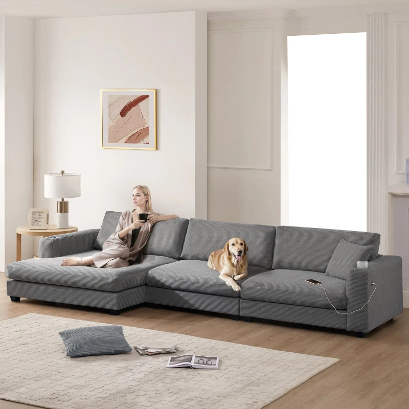 Large gray corduroy sofa with woman and dog relaxing
