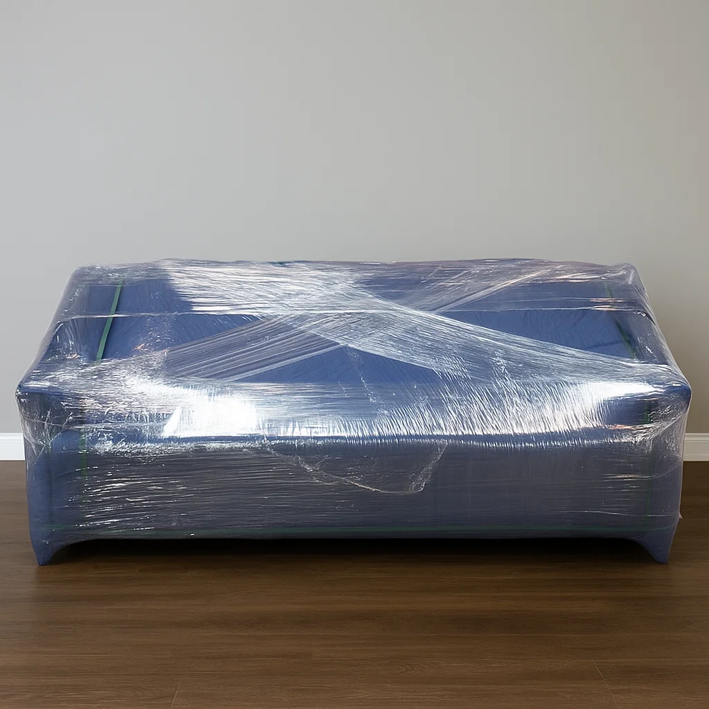 Sofa fully wrapped in protective plastic for moving.