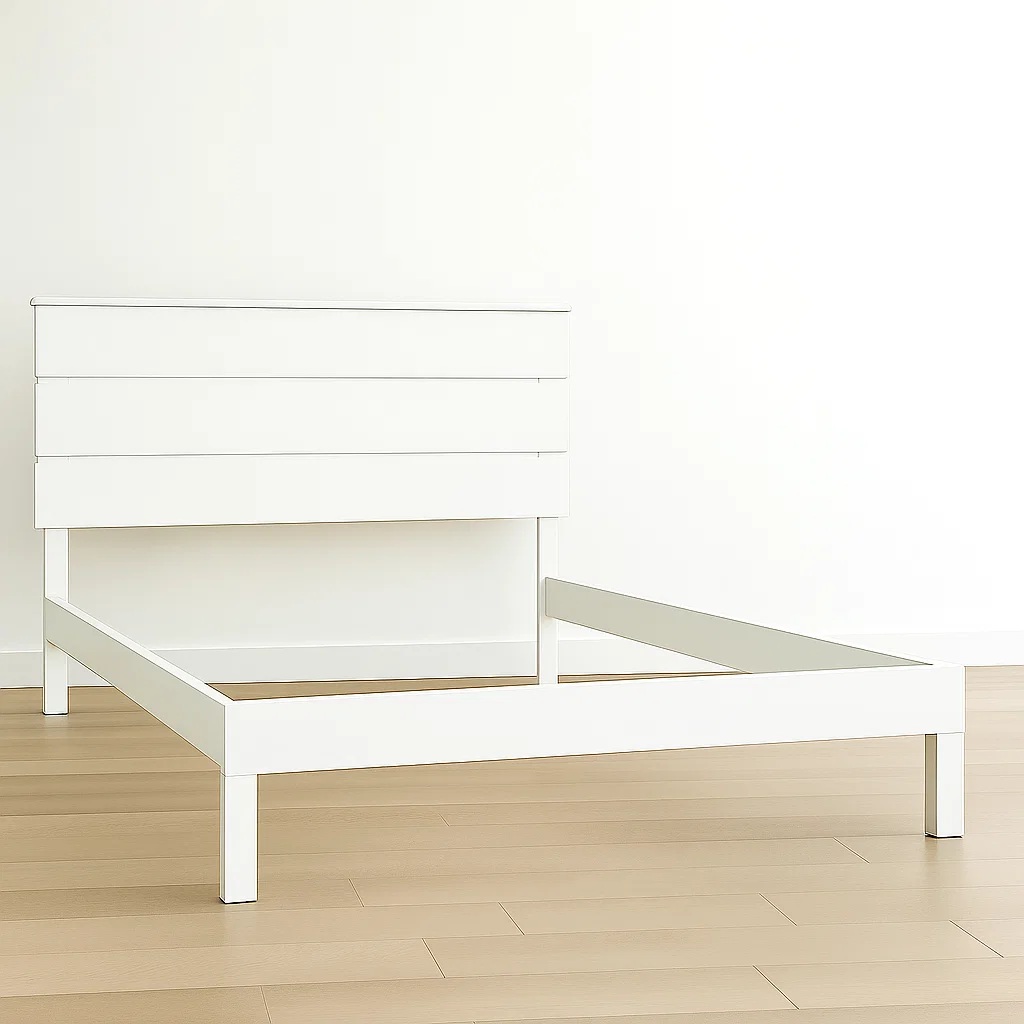 White primed wooden bed frame on light wood flooring.