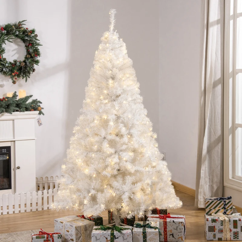 White Christmas tree with glowing lights and wrapped presents underneath.
