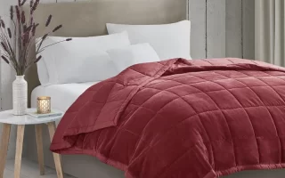 Cozy, styled bed with layered blankets enhancing room ambiance and visual appeal.