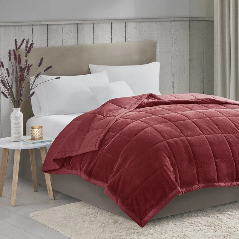 Cozy, styled bed with layered blankets enhancing room ambiance and visual appeal.
