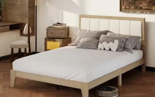 Modern wooden bed with white mattress in a cozy bedroom setting.