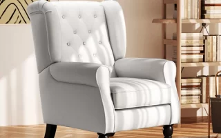 White fabric wingback armchair with tufted backrest in reading area.