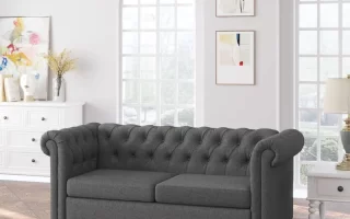 Dark grey tufted loveseat sofa in bright living room
