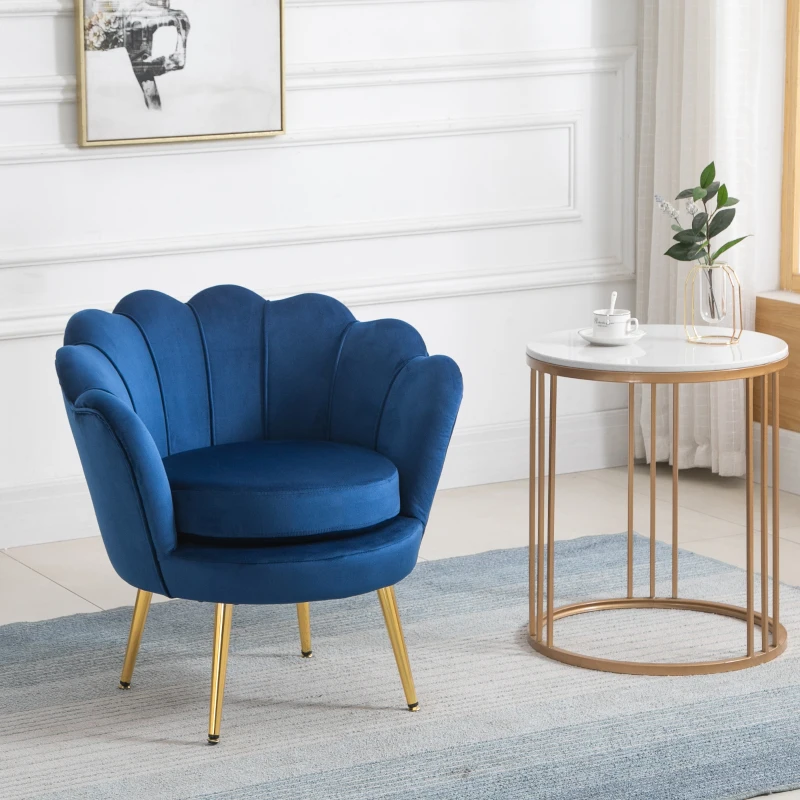 Blue velvet accent chair with gold legs in bright corner.