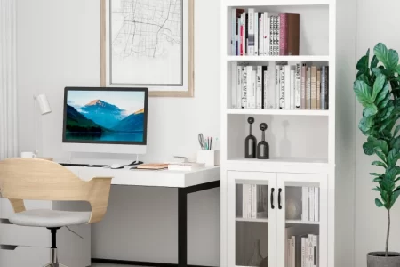 White office hutch cabinet organized with monochrome books and minimalist black and white decor.