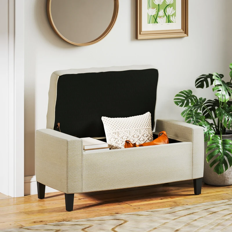 Beige upholstered storage bench with open lid beside plants.
