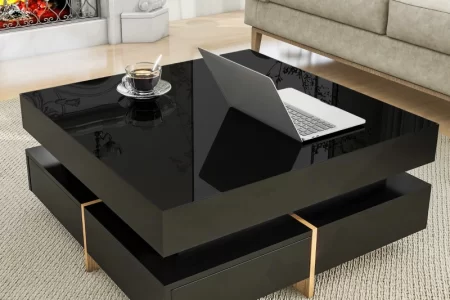 Glossy black square coffee table with laptop