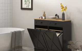 Modern black double laundry cabinet beside bathtub with decor accents.