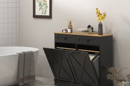 Modern black double laundry cabinet beside bathtub with decor accents.