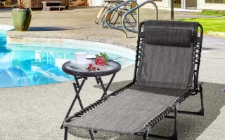 Poolside black lounge chair with side table under umbrella