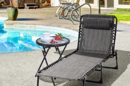 Poolside black lounge chair with side table under umbrella