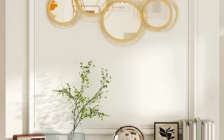 Elegant gold circular wall mirror above marble mantle decor.