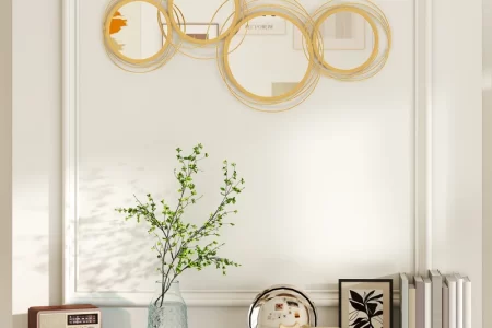 Elegant gold circular wall mirror above marble mantle decor.