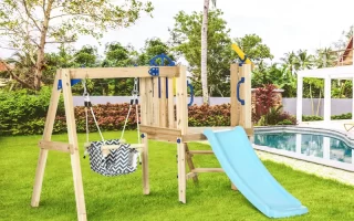 Kids enjoying wooden outdoor playset with swing, slide, and sandbox during Black Friday sale.