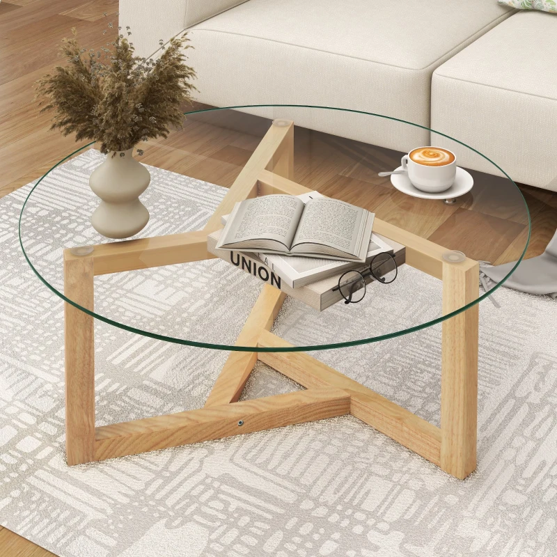 Glass coffee table with wooden star-base holding coffee and books.