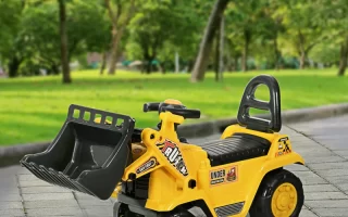 Yellow kids ride-on digger toy with front loader in park