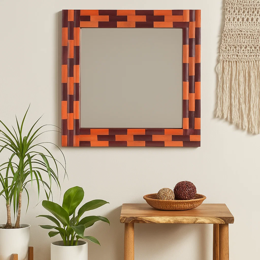 Colorful square mirror with woven frame on white wall.

