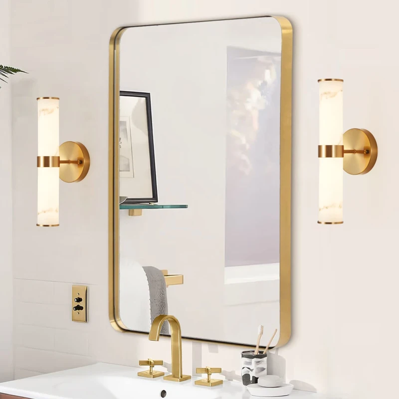 Gold wall sconces beside mirror above modern bathroom sink