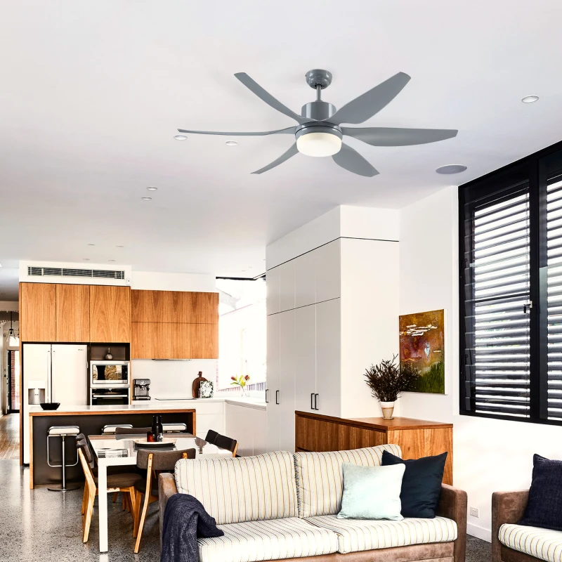 Low-profile flush mount ceiling fan with patterned metal shade adding style to a cozy interior space.
