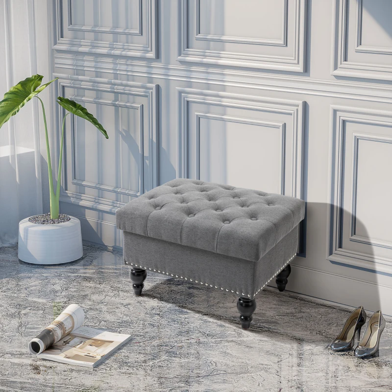 Gray square tufted ottoman with decorative legs in hallway
