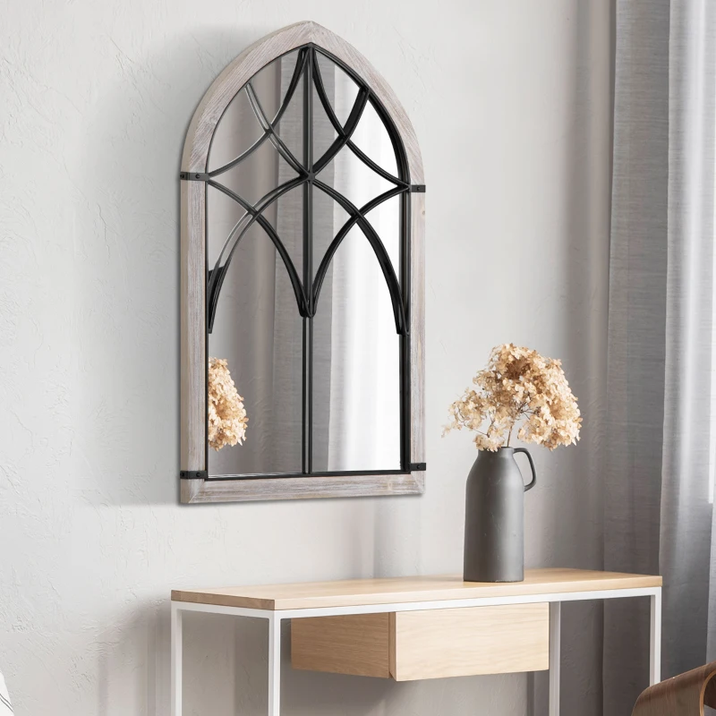 Arched farmhouse wall mirror with black metal frame over console.