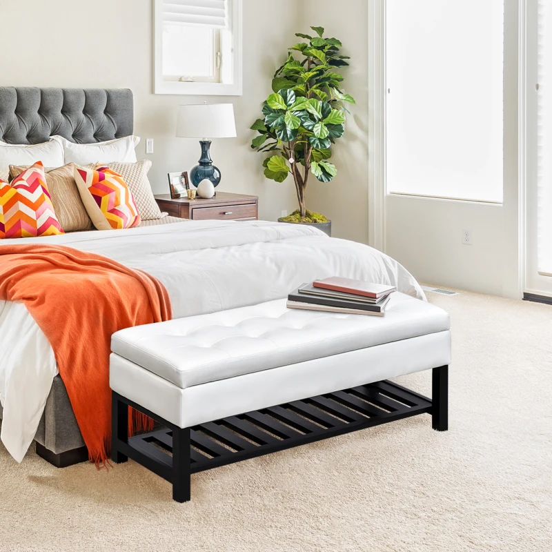 White faux leather ottoman bench with storage shelf in bedroom
