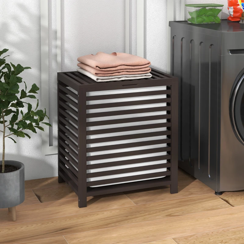 Brown slatted bamboo laundry basket beside washing machine.