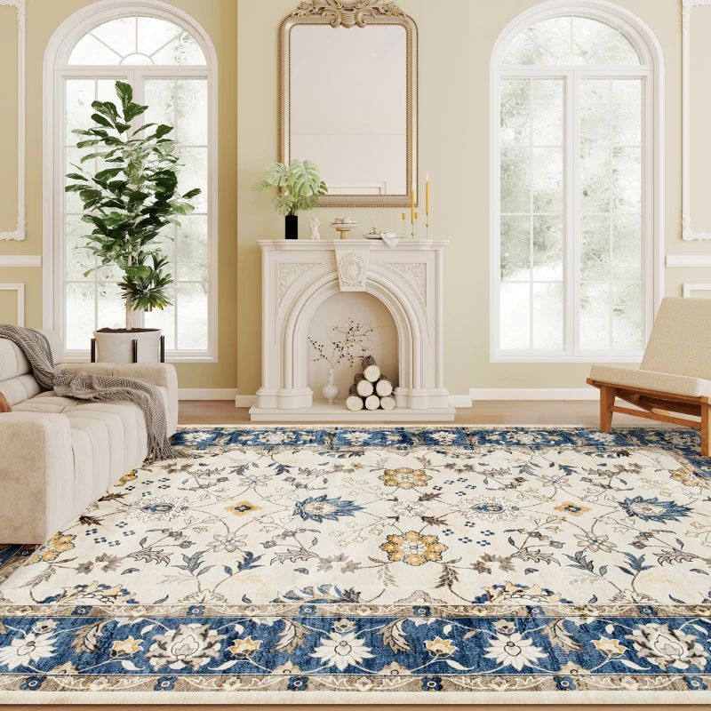 Living room with cream sofa and blue-floral area rug near white fireplace.