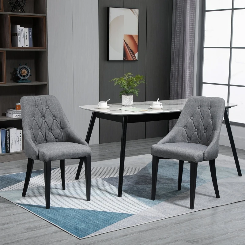 Gray tufted dining chairs with marble-top table in modern room