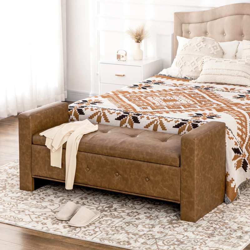 Brown faux leather ottoman bench with tufted seating at bed foot
