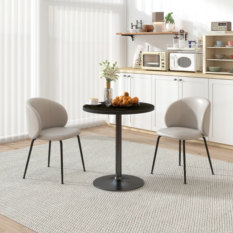 Small round black dining table with two gray chairs in modern kitchen