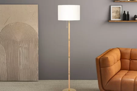 Modern floor lamp beside brown sofa in stylish living room