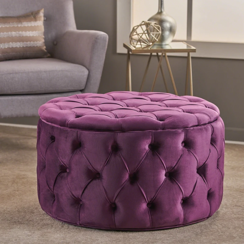 Round purple tufted velvet ottoman in elegant modern room

