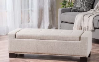 Beige fabric storage ottoman in bright living room with sofa