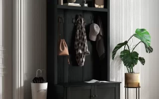 Modern black hall tree with coats, hats, and plants in entryway.