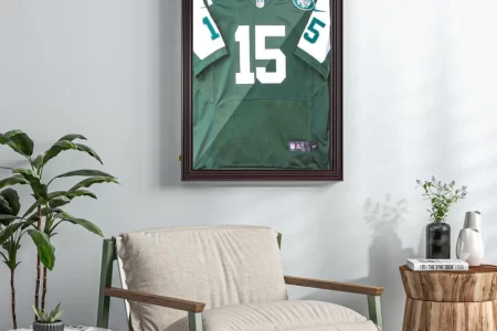 Framed sports jersey displayed on living room wall above chair