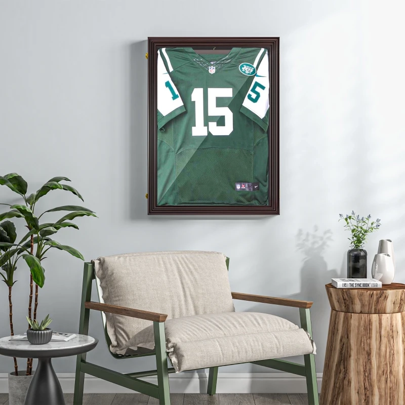 Framed sports jersey displayed on living room wall above chair