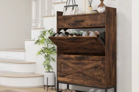 Rustic wooden shoe cabinet in entryway with open drawers displaying shoes.