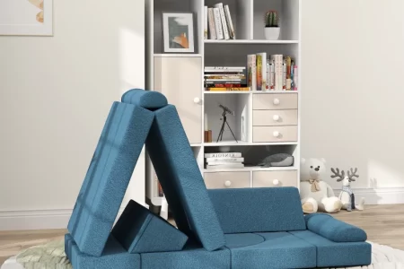 Blue foldable foam play couch arranged in cozy kids’ room.
