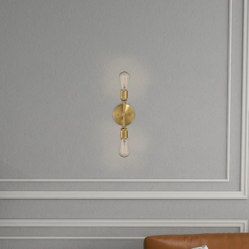 Vertical wall light with gold frame and exposed bulbs on gray wall